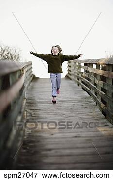 Picture - girl running down 
pier. fotosearch 
- search stock 
photos, pictures, 
images, and photo 
clipart