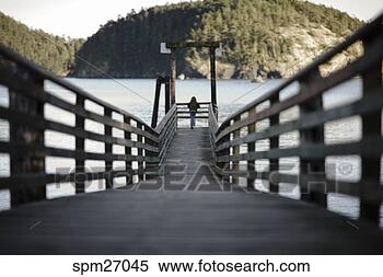 Stock Image - girl standing 
at end of pier. 
fotosearch - search 
stock photos, 
pictures, images, 
and photo clipart