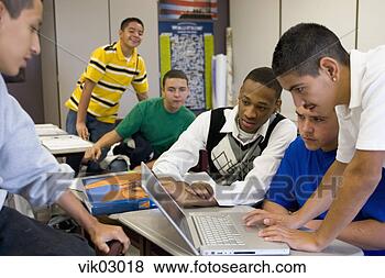 Stock Photo - hispanic and african 
teenagers working 
on laptop in classroo. 
fotosearch - search 
stock photos, 
pictures, images, 
and photo clipart