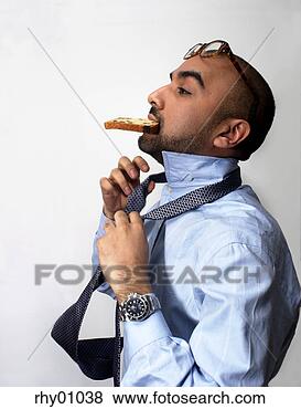 Stock Photo - hispanic businessman 
tying tie while 
eating toast. 
fotosearch - search 
stock photos, 
pictures, images, 
and photo clipart