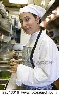 Stock Photograph - hispanic female 
chef cooking in 
kitchen. fotosearch 
- search stock 
photos, pictures, 
images, and photo 
clipart