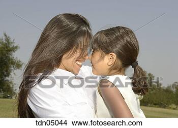 Stock Photo - hispanic mother 
hugging daughter. 
fotosearch - search 
stock photos, 
pictures, images, 
and photo clipart