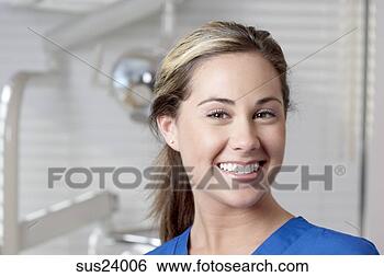 Stock Photo - hispanic nurse 
smiling in doctor's 
office. fotosearch 
- search stock 
photos, pictures, 
images, and photo 
clipart