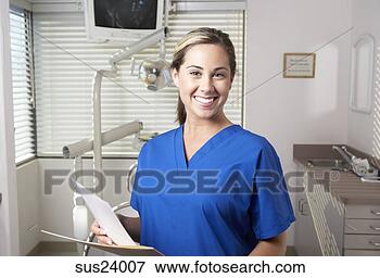 Picture - hispanic nurse 
smiling in doctor's 
office. fotosearch 
- search stock 
photos, pictures, 
images, and photo 
clipart