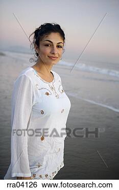 Stock Photo - hispanic woman 
smiling on beach. 
fotosearch - search 
stock photos, 
pictures, images, 
and photo clipart