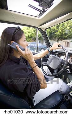 Stock Photography - hispanic woman 
talking on cell 
phone while driving. 
fotosearch - search 
stock photos, 
pictures, images, 
and photo clipart