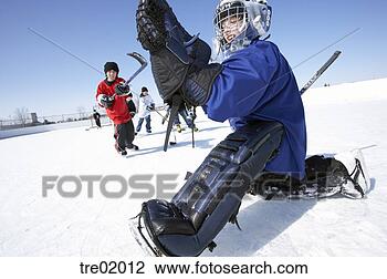 Stock Photo - ice hockey goalie 
saving puck. fotosearch 
- search stock 
photos, pictures, 
images, and photo 
clipart
