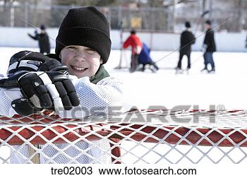 Stock Photo - ice hockey player 
leaning on goal. 
fotosearch - search 
stock photos, 
pictures, images, 
and photo clipart