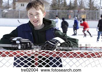 Stock Photo - ice hockey player 
leaning on goal. 
fotosearch - search 
stock photos, 
pictures, images, 
and photo clipart