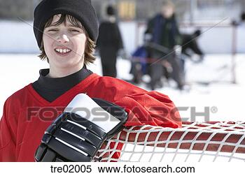 Stock Image - ice hockey player 
leaning on goal. 
fotosearch - search 
stock photos, 
pictures, images, 
and photo clipart