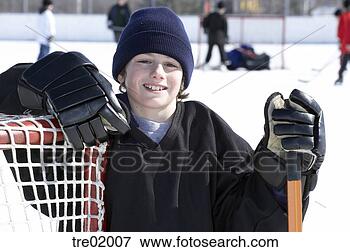 Picture - ice hockey player 
leaning on goal. 
fotosearch - search 
stock photos, 
pictures, images, 
and photo clipart