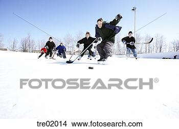 Stock Photo - ice hockey player 
skating towards 
puck. fotosearch 
- search stock 
photos, pictures, 
images, and photo 
clipart