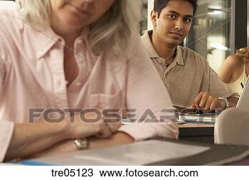 Stock Photo - indian male student 
taking notes in 
class. fotosearch 
- search stock 
photos, pictures, 
images, and photo 
clipart