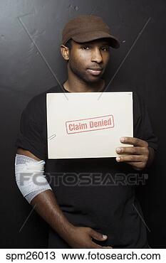 Stock Photo - injured man holding 
