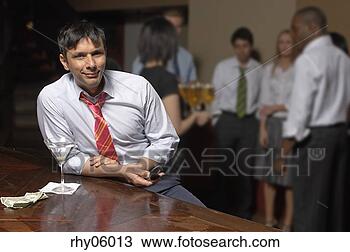 Stock Photo - latino businessman 
at bar with martini. 
fotosearch - search 
stock photos, 
pictures, images, 
and photo clipart