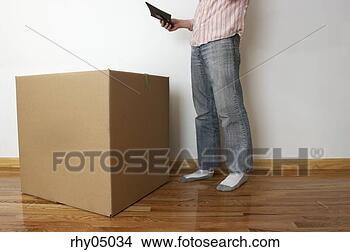 Stock Photo - low section view 
of man near cardboard 
box. fotosearch 
- search stock 
photos, pictures, 
images, and photo 
clipart