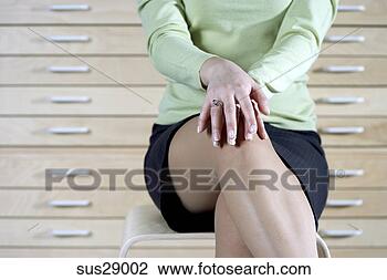Stock Photo - low section view 
of businesswoman 
sitting in front 
of file cabinet. 
fotosearch - search 
stock photos, 
pictures, images, 
and photo clipart