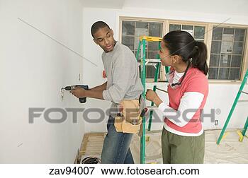 Picture - male carpenter 
using a power 
drill. fotosearch 
- search stock 
photos, pictures, 
images, and photo 
clipart