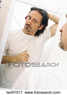 Picture - man brushing hair 
in mirror. fotosearch 
- search stock 
photos, pictures, 
images, and photo 
clipart