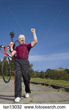 Stock Photo - man carrying bicycle. 
fotosearch - search 
stock photos, 
pictures, images, 
and photo clipart