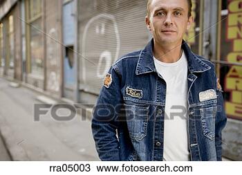 Stock Photo - man in jean jacket 
on urban street. 
fotosearch - search 
stock photos, 
pictures, images, 
and photo clipart