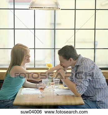Stock Photo - man kissing girlfriend's 
hand in restaurant. 
fotosearch - search 
stock photos, 
pictures, images, 
and photo clipart