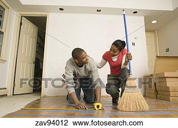 Stock Photo - man measuring 
width of wood 
floor. fotosearch 
- search stock 
photos, pictures, 
images, and photo 
clipart