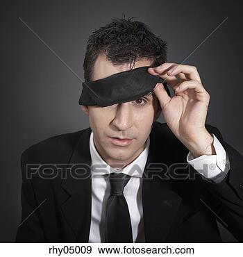 Stock Photograph - man peeking out 
from under a blindfold. 
fotosearch - search 
stock photos, 
pictures, images, 
and photo clipart