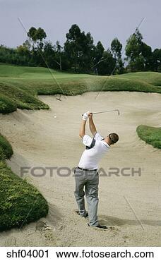 Stock Photography - man playing golf 
out of sand trap. 
fotosearch - search 
stock photos, 
pictures, images, 
and photo clipart
