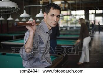 Stock Photography - man with pool 
cue in pool hall. 
fotosearch - search 
stock photos, 
pictures, images, 
and photo clipart
