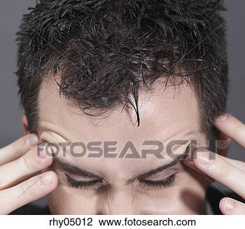 Stock Photo - man rubbing his 
forehead. fotosearch 
- search stock 
photos, pictures, 
images, and photo 
clipart