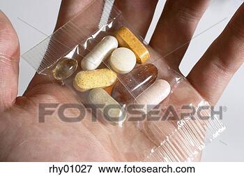 Picture - man's hand holding 
packet of pills. 
fotosearch - search 
stock photos, 
pictures, images, 
and photo clipart