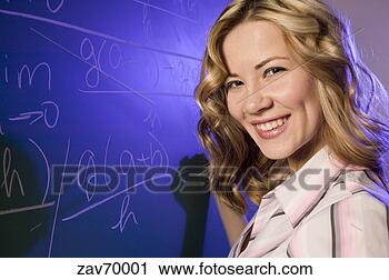 Stock Photography - math teacher writing 
equation on the 
blackboard. fotosearch 
- search stock 
photos, pictures, 
images, and photo 
clipart