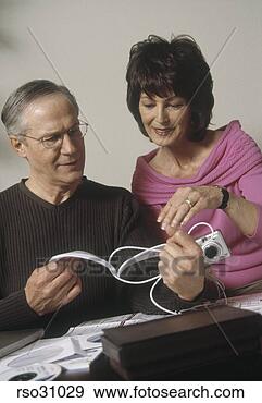 Stock Photograph - mature couple 
reading instruction 
book. fotosearch 
- search stock 
photos, pictures, 
images, and photo 
clipart