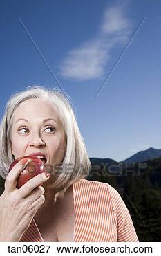 Picture - mature woman eating 
apple. fotosearch 
- search stock 
photos, pictures, 
images, and photo 
clipart