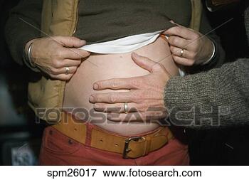 Picture - midsection view 
of husband touching 
pregnant wife's 
stomach. fotosearch 
- search stock 
photos, pictures, 
images, and photo 
clipart