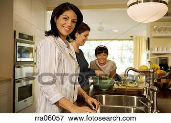 Picture - multi-generation 
family preparing 
meal in kitchen. 
fotosearch - search 
stock photos, 
pictures, images, 
and photo clipart