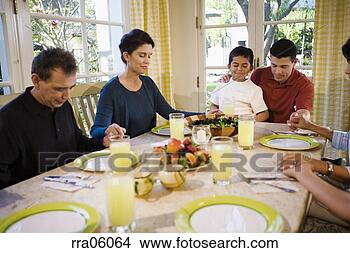 Stock Photo - multi-generation 
family saying 
prayer at dinner 
table. fotosearch 
- search stock 
photos, pictures, 
images, and photo 
clipart