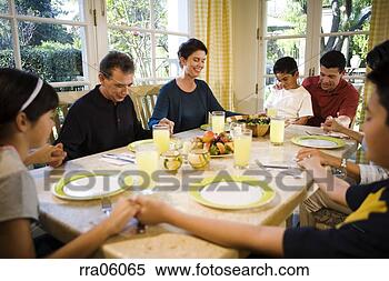 Stock Image - multi-generation 
family saying 
prayer at dinner 
table. fotosearch 
- search stock 
photos, pictures, 
images, and photo 
clipart