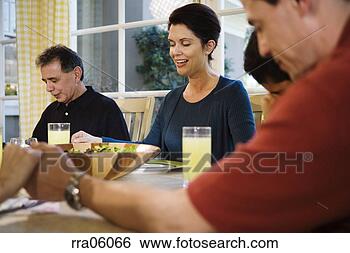 Stock Photo - multi-generation 
family saying 
prayer at dinner 
table. fotosearch 
- search stock 
photos, pictures, 
images, and photo 
clipart