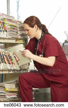 Stock Photo - nurse near push 
cart looking through 
medical records. 
fotosearch - search 
stock photos, 
pictures, images, 
and photo clipart