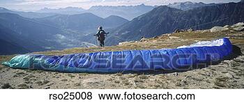 Stock Photo - panoramic view 
of parachuter 
on cliff. fotosearch 
- search stock 
photos, pictures, 
images, and photo 
clipart