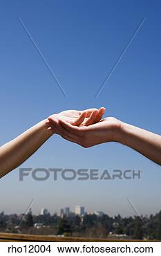 Stock Photo - people cupping 
hands above cityscape. 
fotosearch - search 
stock photos, 
pictures, images, 
and photo clipart