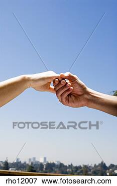 Picture - people holding 
hands above cityscape. 
fotosearch - search 
stock photos, 
pictures, images, 
and photo clipart