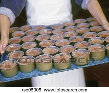 Stock Image - person holding 
tray of canned 
fish. fotosearch 
- search stock 
photos, pictures, 
images, and photo 
clipart