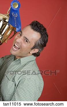 Stock Image - proud man with 
trophy. fotosearch 
- search stock 
photos, pictures, 
images, and photo 
clipart