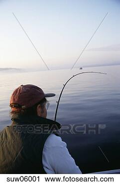 Stock Photography - rear view of man 
with fishing rod. 
fotosearch - search 
stock photos, 
pictures, images, 
and photo clipart