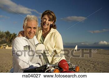 Picture - senior couple 
laughing and riding 
moped. fotosearch 
- search stock 
photos, pictures, 
images, and photo 
clipart