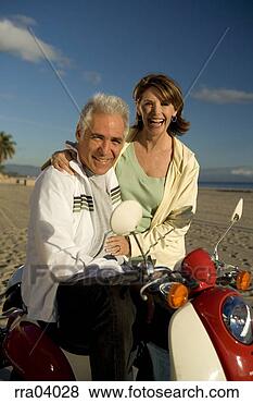 Stock Photo - senior couple 
laughing and riding 
moped. fotosearch 
- search stock 
photos, pictures, 
images, and photo 
clipart