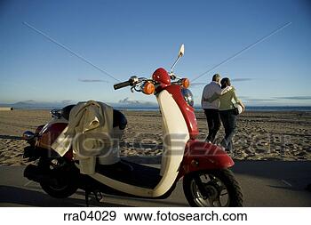 Stock Photograph - senior couple 
walking away from 
moped. fotosearch 
- search stock 
photos, pictures, 
images, and photo 
clipart